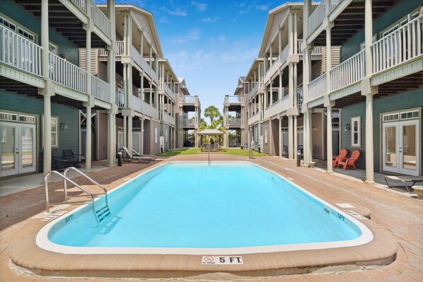 Spacious gated courtyard with pool just steps from the patio.