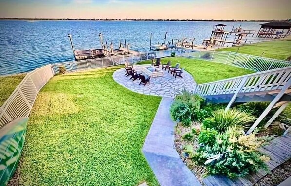 Fenced in Backyard, private dock with boat lift, beautiful landscaping.
