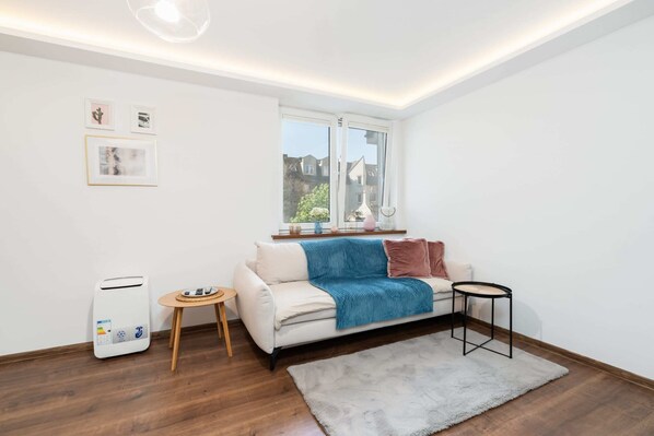 The living room's minimalist decor that enhances its elegant and modern feel.