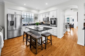 Fully equipped kitchen with barstool seating.