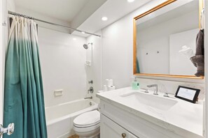 Bright and stylish bathroom featuring a tiled shower, and minimalist design