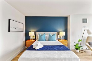 Cozy bed with tropical accents and elegant lighting