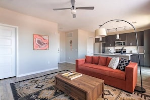 Living room with futon; note that your living room layout and decor might be slightly different since we have multiple units in this building with slightly different layouts!