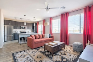 Living room with futon; note that your living room layout and decor might be slightly different since we have multiple units in this building with slightly different layouts!