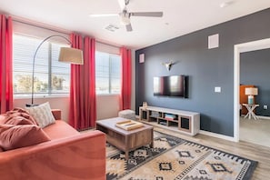 Living room with futon; note that your living room layout and decor might be slightly different since we have multiple units in this building with slightly different layouts!