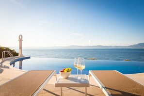 Sea view from the sun loungers by the semi-circular pool of the Croatian luxury villa Sutivan Infinity on Brac island