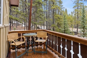 The front porch features a bistro style table and chairs providing a great spot to enjoy your morning coffee or happy hour out in the sunshine.