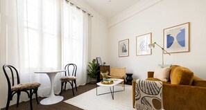Living room with a suede sofa and two-seater table and chair