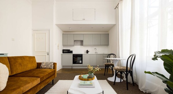 Living room with a suede sofa and two-seater table and chair