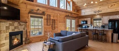 Open living room with lots of natural light and fire place.