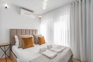 The serene white decor creates a soothing ambiance. Enjoy a comfortable stay in our bedroom with a queen-size bed, basking in the refreshing brightness #stunning #simple