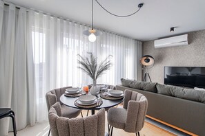 Gather around the dining table, adorned with tasteful decor, and savor delicious dishes while basking in the cozy ambiance of this inviting space. #lovely #airbnbporto