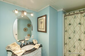 With a breezey theme, the vanity offers a well lit mirror.