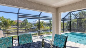 Al fresco dining area overlooking the pool and canal