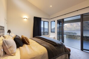 Master bedroom with lake views and balcony