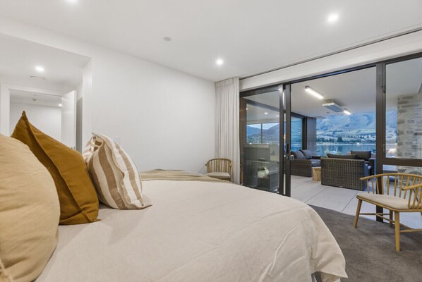 Master bedroom with balcony and lake views