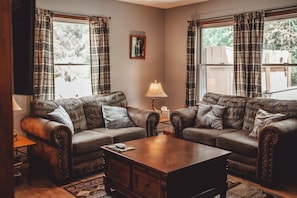 Relax on two comfortable couches with a huge coffee table.