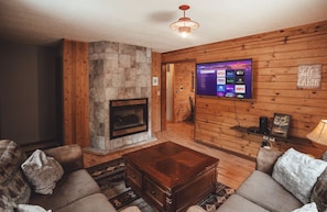 The spacious living room with two couches & 55" smart TV