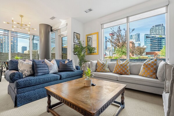 Welcome home! Steps to the Saddledome, BMO centre, Stampede grounds and more. This corner suite offers two bedrooms, two bathrooms and an expansive private rooftop patio that spans two sides of the suite,  offering lounging, dining and tanning space. 