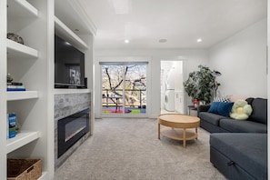 The biggest and coziest living space with a sofabed, TV, fire place and lounging area