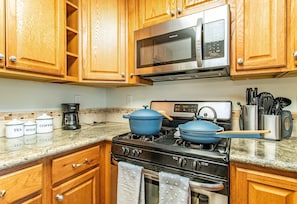New, stainless steel appliances and granite countertops for enjoying home meals