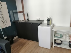 Kitchenette with fridge and Nespresso coffee machine. Microwave + hob