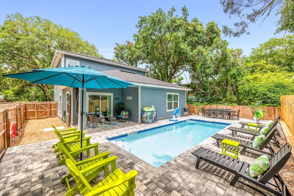 Escape to your own tropical oasis: enjoy the heated saltwater pool, charcoal grill, and outdoor shower!
