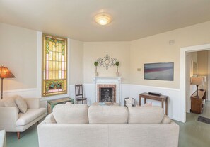 Living Room with Candle-Lit Fireplace and HDTV