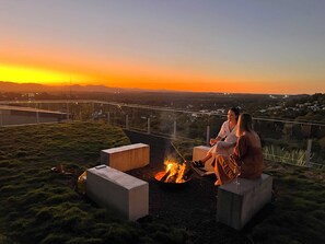 Cosy up by the beautiful, rooftop fire pit. (Available ONLY during the safe fire season winter months).