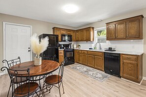 Kitchen featuring fridge, oven, microwave, and dishwasher