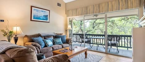 Cozy living room with direct walk out to the private balcony overlooking the pool.