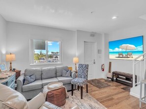 Living Room with Large Smart TV, Window Facing the Marina that captures breathtaking sunrises
