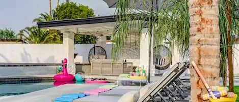 Lounge chairs, floaties, outdoor seating with TV!