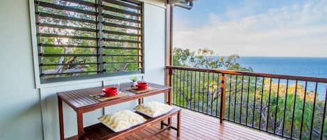 Rear entertaining deck with superb views down to Sunrise beach and vast sapphire expanse to the horizon