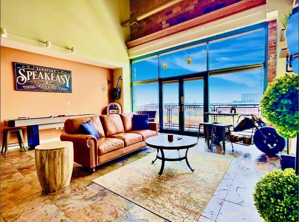 Enjoy our welcoming living room, where a plush leather couch and chairs await your comfort. Dominating the space is a magnificent 75-inch HD TV, ready to elevate your vacation relaxation with endless entertainment options. 