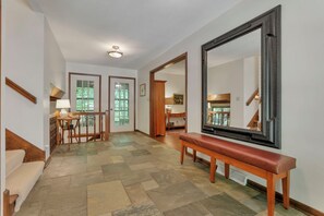 Front entry hall is on the same level as the living room, kitchen, dining room and sitting room. There is a half bath off the sitting area.