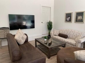 Living room with 65 inch smart TV and sofa bed