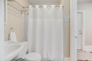 A full bath on the first floor offers easy access without any stairs. ADA height toilet and grab bars for the toilet and tub make this space friendly for people with mobility challenges.