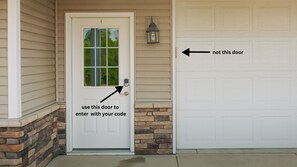 Enter your code in the Entry Door located to the left of the garage door 