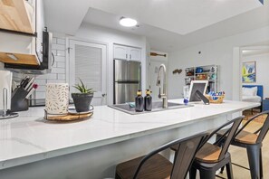 Remodeled kitchen with quartz countertops, bar stools & a full stocked kitchen!