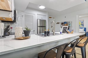 Remodeled kitchen with quartz countertops, bar stools & a full stocked kitchen!