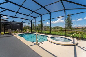 View of pool and spa with entry assist bars