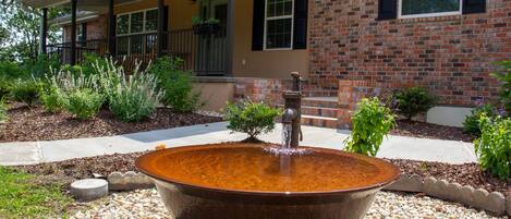 Sugar kettle and antique pump in front yard