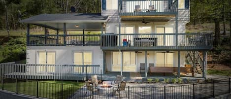 Backside view of the home with a spacious patio. 