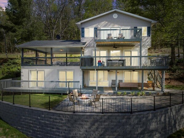 Backside view of the home with a spacious patio. 