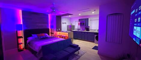 Spacious Studio with queen bed and futon, modern design with LED mood lighting.