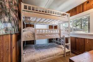 A bedroom located near the kitchen is perfect for sharing with a triple bunk bed all full-size making it comfortable for all in the room.
