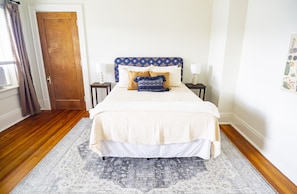 This bedroom has a large closet and bedside tables provide light and USB charger