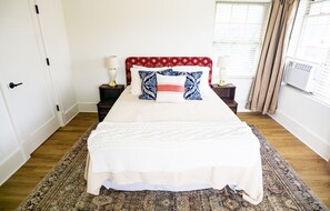 The queen bed has a custom headboard with imported Turkish fabric.