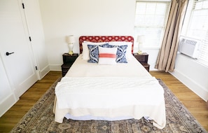 The queen bed has a custom headboard with imported Turkish fabric.